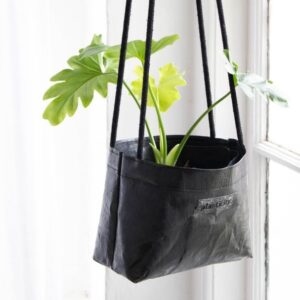 Plasticity upcycled hanging planters are finished with hemp cord handles.