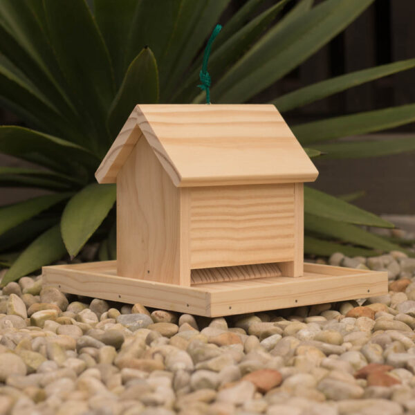 Wild bird seed house with tray for feeding garden birds.