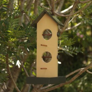 The fruit and nut bird feeder painted with dark khaki and beige paint and varnished for extra protection against the weather.