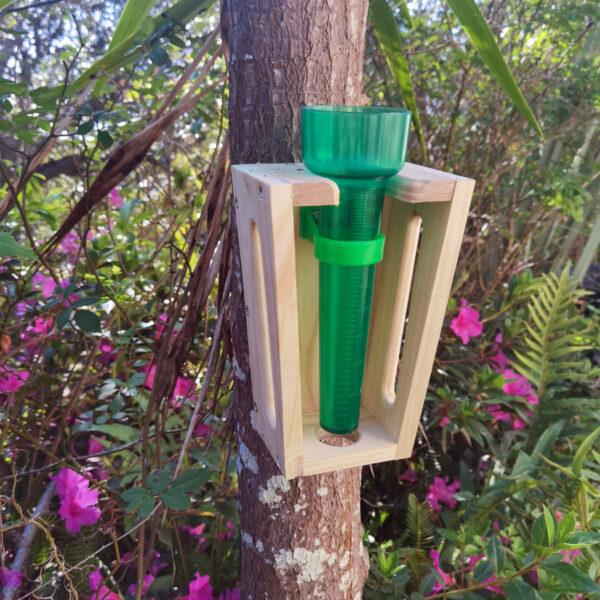 Amanzi measure rain gauge mounted against a tree.