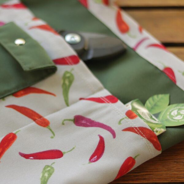 Close-up detail of the gardening apron in chili print.